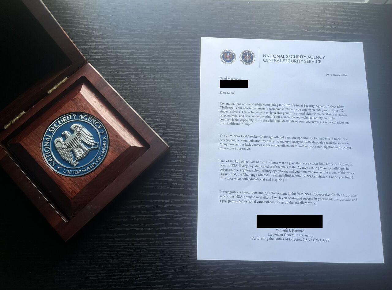 The NSA congratulatory letter signed by the Director, beside the NSA-branded medallion